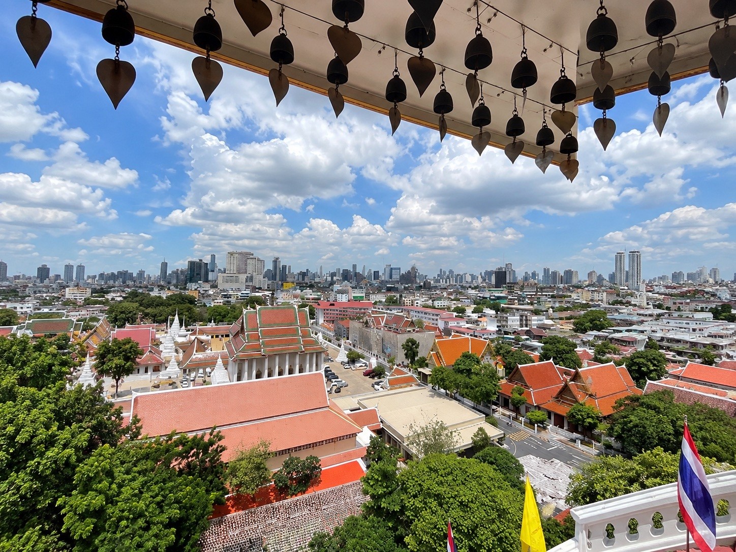 Temple rooftops of Wat Saket seen from beneath the bells at the top of the Golden Mount