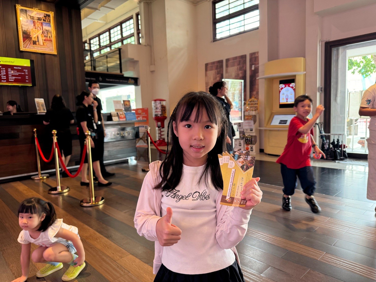 Children holding their exhibition tickets in the lobby of Rattanakosin Exhibition Hall