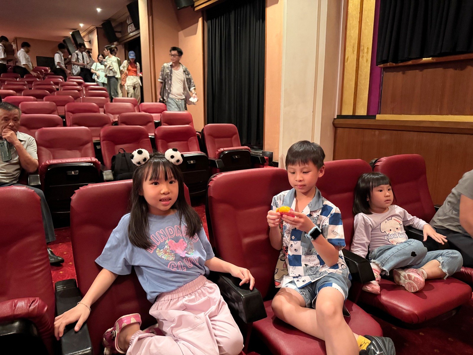 Children seated inside Sala Chalermkrung before the performance