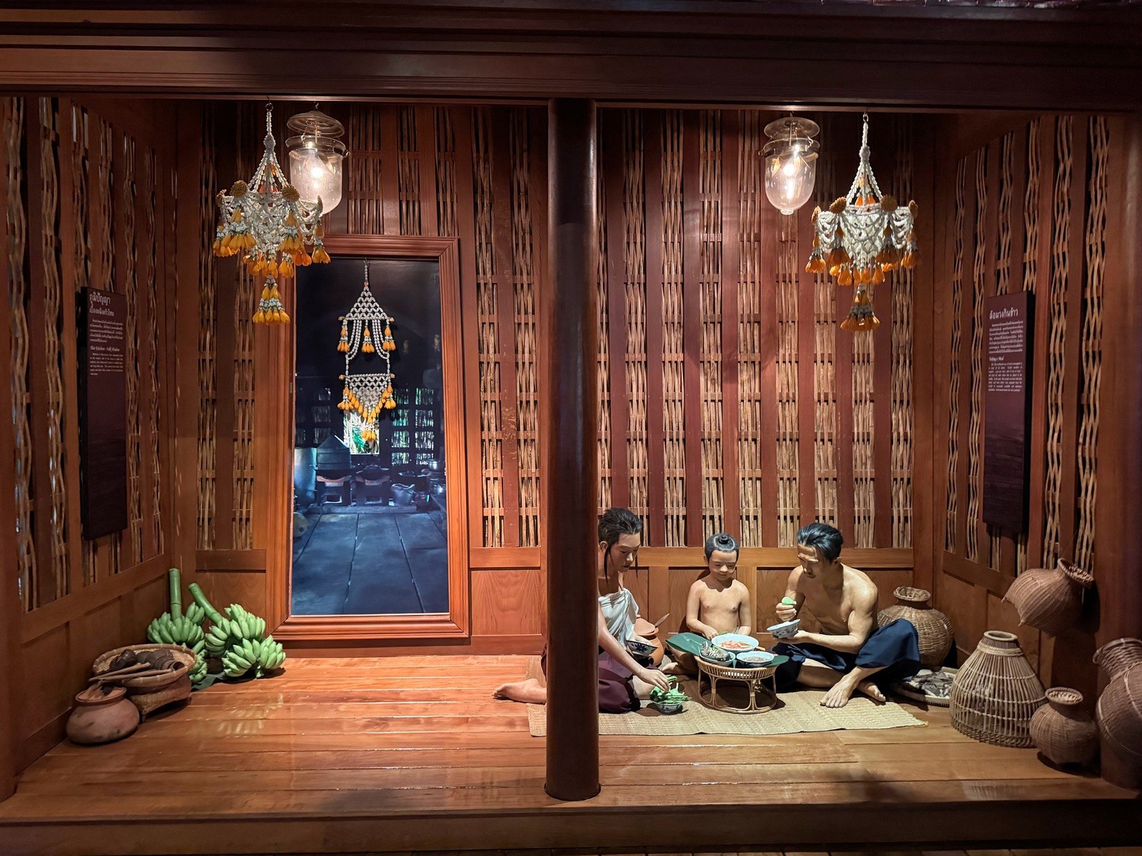 Recreated scene of a traditional Thai home with figures at Rattanakosin Exhibition Hall
